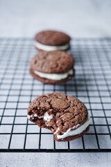 Bitten whoopie pies on a baking grid.