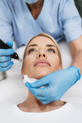 Fototapeta premium Microneedle mesotherapy. Beautiful blond woman receiving microneedling rejuvenation treatment.
