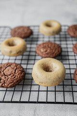 Donuts and whoopie pies on a baking grid.