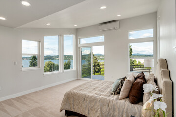 Restful bedroom interior with master bed placed under a sloped ceiling.
