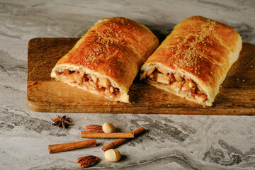  Traditional puff strudel with apple filling Two slices of apple strudel on the marble table. High quality illustration