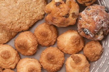 Cakes assort on a ceramic plate, close up