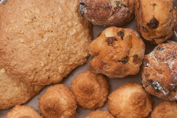 Cakes assort on a ceramic plate, close up