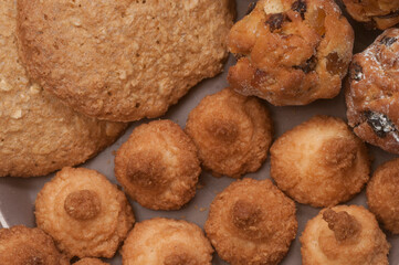 Cakes assort on a ceramic plate, close up