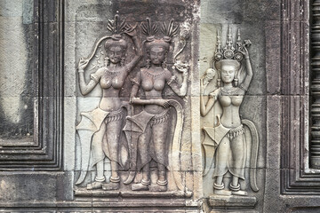 Female dancers carvings on the walls of Angkor Wat complex in Cambodia