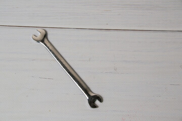 Wrench on wooden background with copy space.