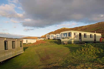 Fototapeta na wymiar Static caravan holiday homes at Llangennith on the Gower Peninsular in winter which is out of season, the caravans are closed up until spring.