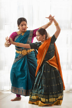 Dancer teaching bharatanatyam to girl