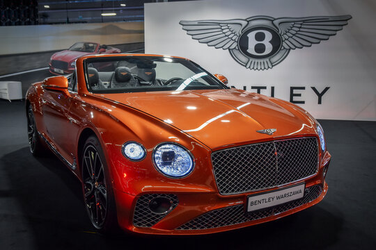 Orange Bentley New Continental GT Convertible on motorshow. Selective focus.