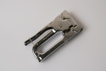 The concept of repair and construction. Construction stapler on a gray background view from the top