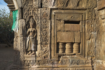 Stone carvings on the wall of ancient Nokor Bachay pagoda in Kampong Cham, Cambodia