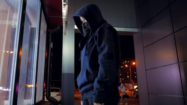 girl a marauder looks at a shop window that wants to rob