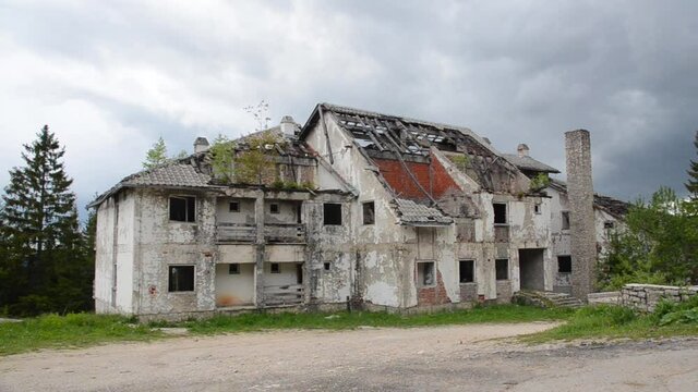 Building in ruins. Ruined and damaged building as war aftermath in Bosnia and Herzegovina. Houses destroyed and burned in war by artillery. Abandoned buildings  
