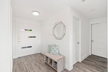 Fototapeta na wymiar Beautiful white hallway interior with grey hardwood floors