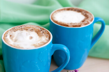 Cappuccino coffee in beautiful blue cups. Spring mood with a Cup of coffee.