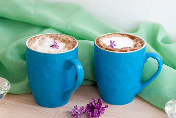 Cappuccino coffee in beautiful blue cups. Spring mood with a Cup of coffee.