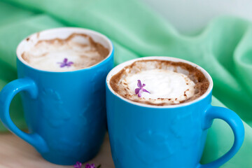 Cappuccino coffee in beautiful blue cups. Spring mood with a Cup of coffee.