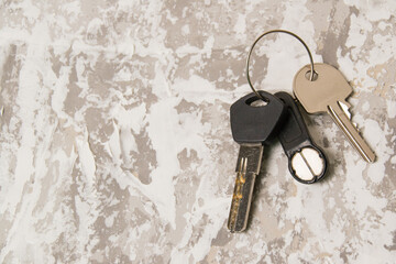Keys to the apartment or house, intercom key on a light wooden background.