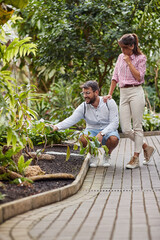 young caucasian tourist couple in a botanical garden, enjoying
