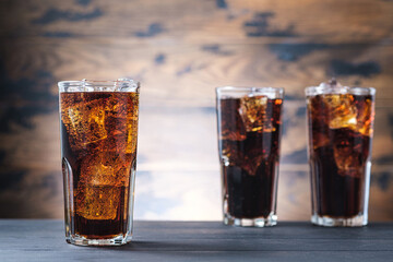 Three glass with cola and ice cubes. Cold fizzy drink