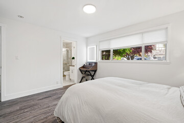 White and grey bedroom with a freestanding makeup vanity