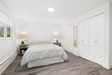 White and grey bedroom with floor to ceiling wardrobe cabinets