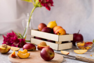 nectarine on the cutting Board in the kitchen. fresh fruit on the table in the drawer
