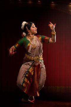 Bharatnatyam dancer playing veena during her graceful performance. 
