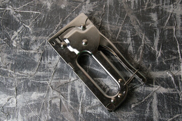 The concept of repair and construction. Construction brackets and stapler on the background of dark...