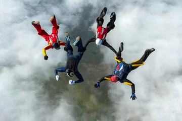 Poster Sports parachutist build a figure in free fall. Extreme sport concept. © German Skydiver