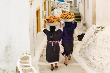 easter bread carrying by woman in a black traditional dress in Olympos, Karpathos Greece
