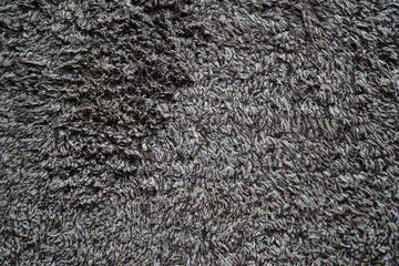 Close up used white - gray - brown doormat for any old vintage design style.