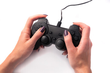 Black gamepad in female hands on a white background