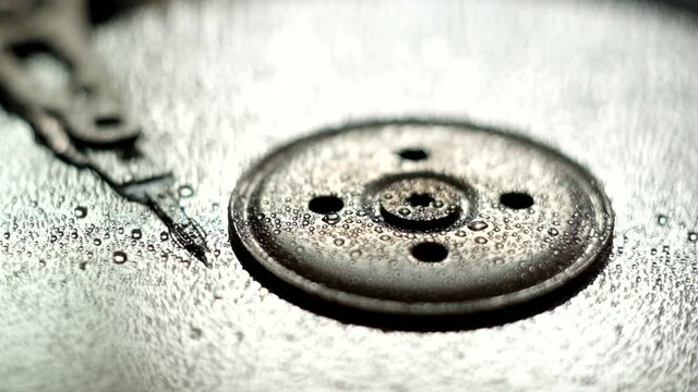 Open HHD under the falling rain. Droplets on open hard disc.