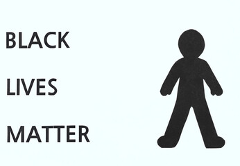 Black Lives Matter flat lay with black paper silhouette on a white background. Stop police brutality, racism and discrimination concepts.