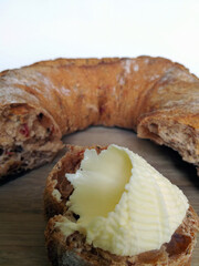 fresh tasty crispy delicious bread with butter on a wooden plate