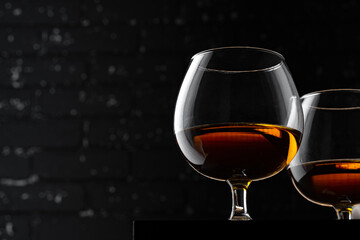 Whisky glass against dark black grunge wall