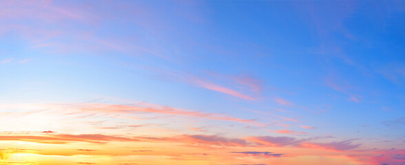 Fototapeta premium panorama of a blue-pink sunset with clouds of pink hues. sunset on the horizon. photo for the banner. space for text.