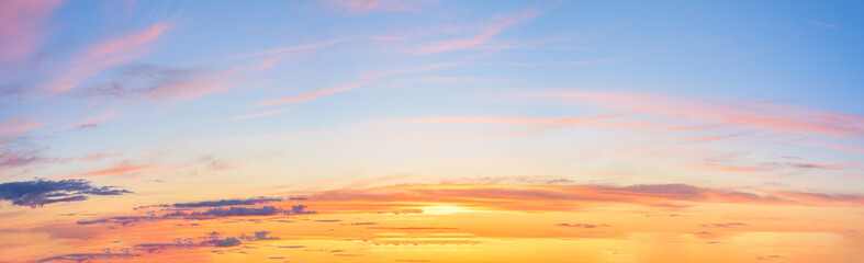 panorama of a blue-pink sunset with clouds of pink hues. sunset on the horizon. photo for the banner. space for text.