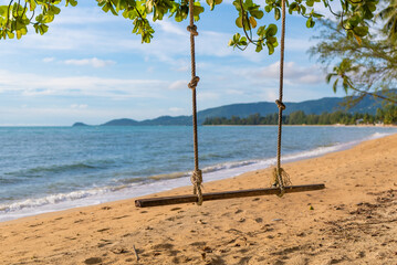 swing on the beach of the paradise island of Koh Samui in Thailand, a sunny beach, sunbathing and swimming in the sea, blue ocean and sky, travel to the resort, relaxation and enjoyment