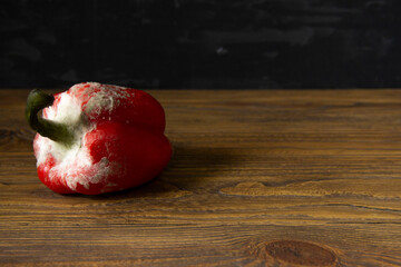 rotten red pepper on wooden background
