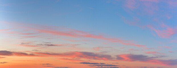 panorama of a blue-pink sunset with clouds of pink hues. sunset on the horizon. photo for the banner. space for text.