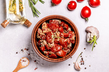 Bowl of sun dried tomatoes garlic, oregano, olive oil, top view