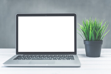 Fototapeta premium home and office workspace concept, laptop mockup. Laptop computer white blank screen on work table front view. Copy space
