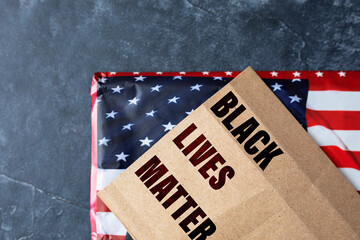 feet in sneakers on a dark background with the text Black Lives Matter. the concept of protests in...