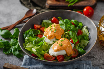 Organic egg benedict with salad