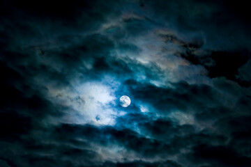 Naklejka na ściany i meble Night moon behind the dark clouds