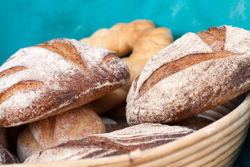 Bread in a basket at the blue background during daytime