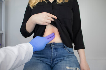 A woman holds on to his stomach. Pain in the abdominal cavity. The concept of diseases of the...