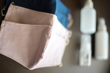 Facemasks on Dark Background with three bottles of sanitizers A respirator protects the wearer from inhaling hazardous atmospheres, including fumes, vapors, gases and particulate matter such as dusts